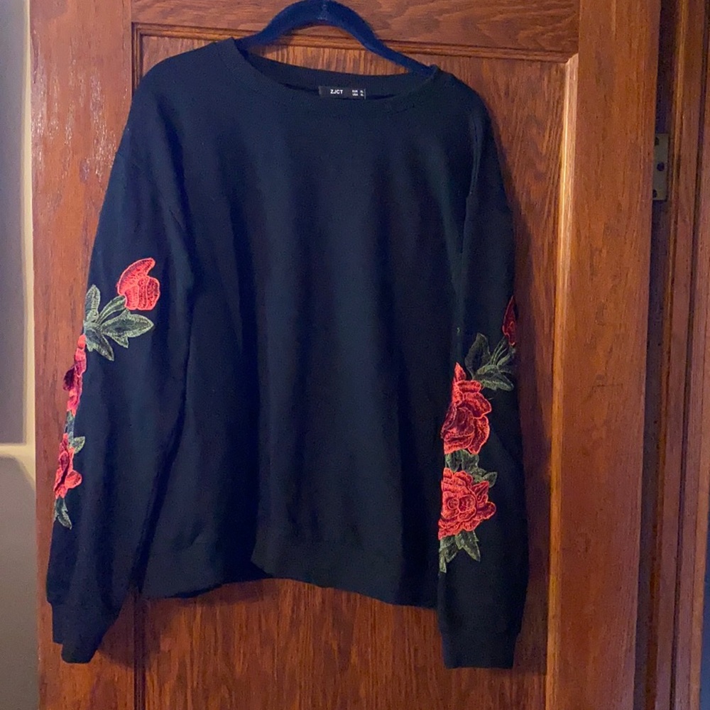 Black sweatshirt with detailing on arms